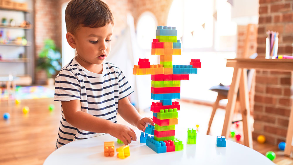 Toddler playing with Duplo Legos